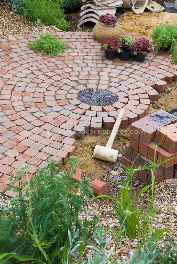 Building a patio with brick pavers in garden construction